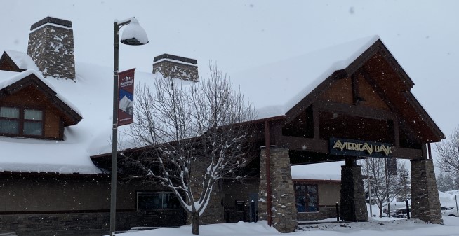 Outside view of American Bank in Big Sky, Montana with snow covered roof.