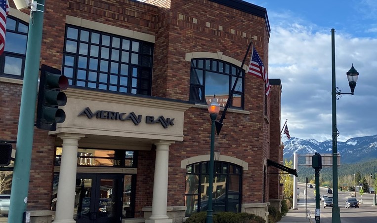 Street view of American Bank in Whitefish, Montana, with red brick exterior walls